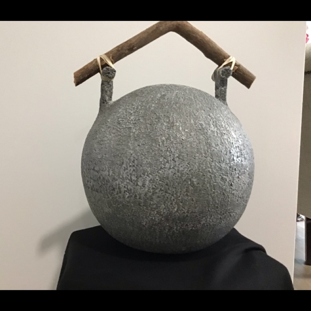 A clay ceramic sphere 13 inches high and 16 pounds